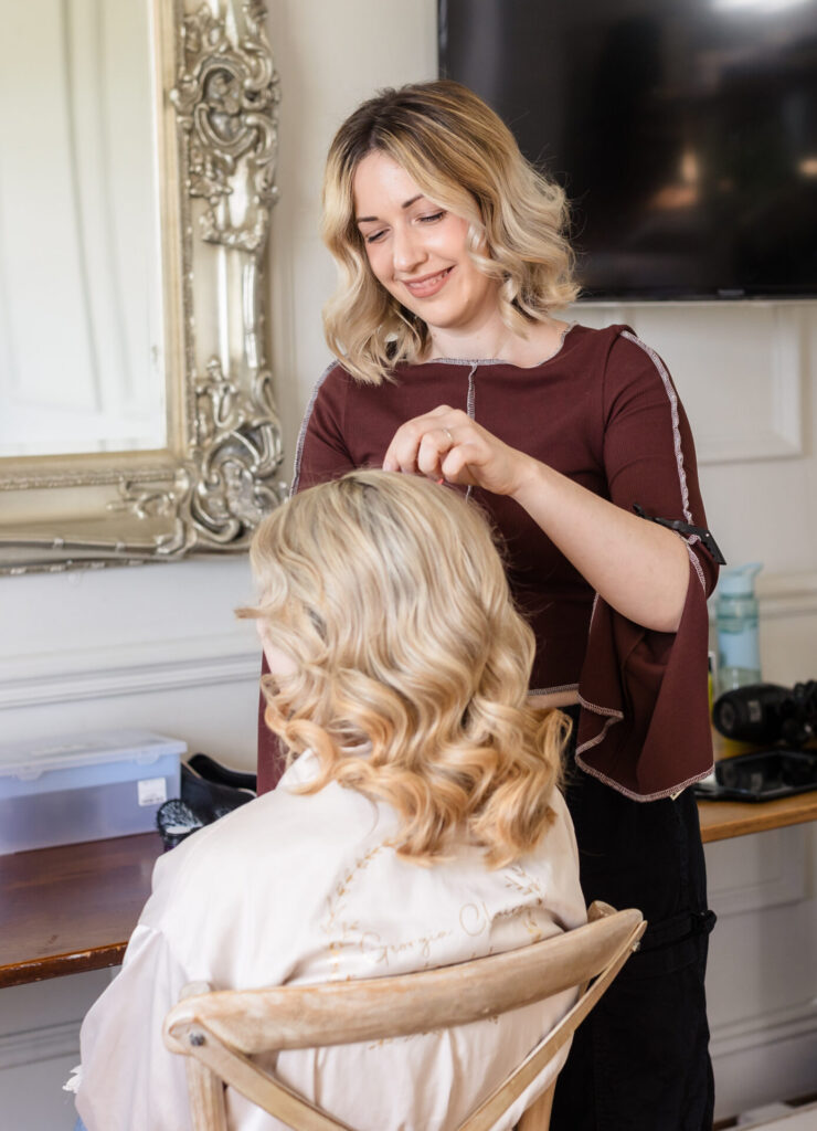 Georgia creating a wedding hair style for a bride