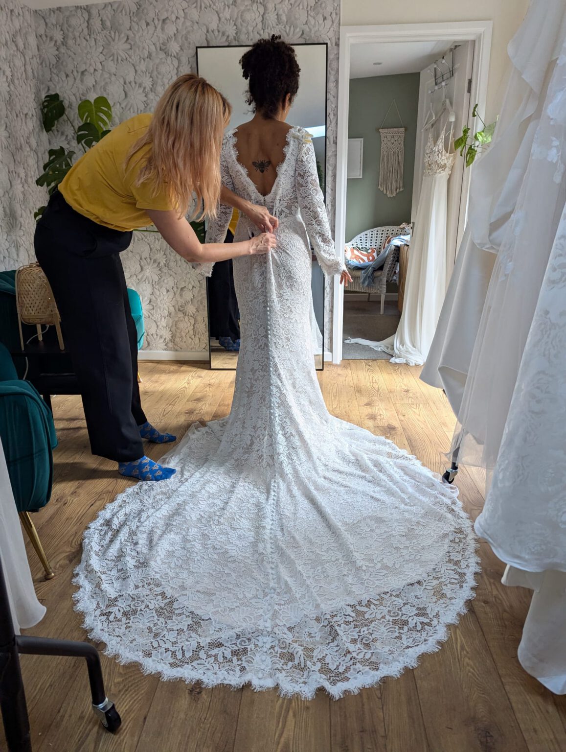 Photograph of Zoe from Bys Vyken Bridal boutique, Bristol helping with a dress fitting