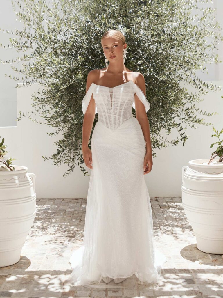 Photograph of a model wearing a Serene by Madi Lane wedding dress